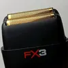 A close-up view of the head of a black electric shaver with gold foils. Anteprima dell’immagine prodotto
