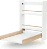 A white wall-mounted changing table with wooden accents, shown in an open position. Anteprima dell’immagine prodotto