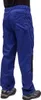 A person wearing blue work pants and gray shoes, shown from the back. Produktbild-Vorschau