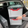 Two folding crates are being loaded into the trunk of a car. Produktbild-Vorschau
