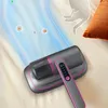 A handheld vacuum cleaner is shown on a bed, with animated blue lines indicating suction and small circular graphics representing dust mites being removed. A faint outline of a cat and a pillow are also visible. Produktbild-Vorschau