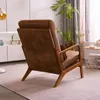 A brown armchair is placed in a living room setting with plants and blinds in the background. Náhľad obrázku produktu