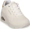 A white Skechers Uno sneaker with gold accents. Voir les images du produit