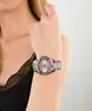 A woman's arm wearing a multicolor Guess watch. Náhľad obrázku produktu