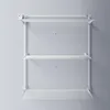 A white vertical wall-mounted drying rack with three tiers, shown against a light gray wall. Produktbild-Vorschau