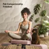 A woman meditates on a pink office chair with a small brown dog sitting next to her. Podgląd zdjęcia produktu