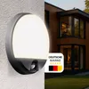 A split image showing an LED outdoor wall light with a motion sensor on the left, and a modern wooden house with large windows on the right. Produktbild-Vorschau