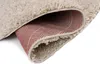 A close-up view of a beige rug, showing the underside with a red and white striped pattern. Anteprima dell’immagine prodotto