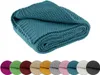 A folded teal knitted blanket is shown on a white background, with a row of colored swatches below. Náhled obrázku produktu
