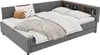 A grey upholstered daybed with a corner headboard featuring a wooden shelf. The bed is made with white linens, a patterned duvet, and several pillows and a throw blanket. Anteprima dell’immagine prodotto
