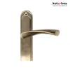 A close-up studio shot of a bronze-colored door handle with a long escutcheon plate, set against a white background. The brand logo and slogan are visible in the top right corner. Produktbild-Vorschau