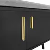 A close-up view of a black cabinet with gold handles and a gray upholstered top. Anteprima dell’immagine prodotto
