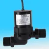 A close-up shot of a black solar water pump against a blue background. Voir les images du produit