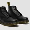 A pair of black leather Dr. Martens boots on a white background. Voir les images du produit