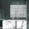 A modern bathtub with a glass shower screen featuring a striped pattern. Produktbild-Vorschau