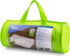 A green cylindrical bag containing a white wedge-shaped pillow with bamboo imagery on its packaging. Náhled obrázku produktu