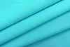 A close-up view of turquoise fabric folded to show its texture and sheen. Produktbild-Vorschau