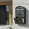 A mailbox mounted on a wall next to a house entrance. Náhľad obrázku produktu