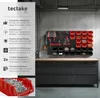 A workshop wall with a tool organizer system, including bins and hooks, mounted above a workbench. Produktbild-Vorschau