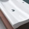 A close-up view of a white ceramic sink with a chrome drain. Produktbild-Vorschau