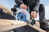 A person is using a circular saw to cut wood on a roof. Produktbild-Vorschau