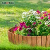 A wooden garden border filled with colorful flowers and greenery, set against a backdrop of lush grass. Produktbild-Vorschau