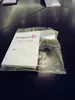 A product in its packaging, likely an instruction manual and accessories for a steam iron press, is placed on a dark, reflective surface. Produktbild-Vorschau