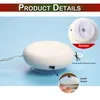 A close-up view of a white, round product with a suction cup base, showing details like a switch and a hook. The product is set against a light blue background. Produktbild-Vorschau