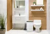 A modern bathroom with a toilet, sink, and laundry basket. Náhľad obrázku produktu