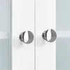 Close-up of two silver cabinet knobs on white cabinet doors. Produktbild-Vorschau