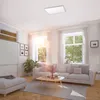 A bright and airy living room with a sofa, coffee table, and large windows. Produktbild-Vorschau