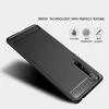 A black phone case with a brushed texture is shown at an angle against a light gray and white background. Text and icons describing the features of the case are displayed above the product. Náhled obrázku produktu