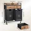 A laundry cart with two bags and two drawers, shown with dimensions and weight capacity. Voir les images du produit