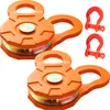 Two orange snatch blocks and two red shackles are arranged on a white background. Náhled obrázku produktu