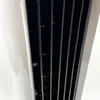 A close-up view of the grill of a white appliance. Produktbild-Vorschau
