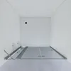 A shower enclosure with glass doors and metal framing, set against white walls. Produktbild-Vorschau