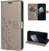 A collage of images showing a gray flip wallet phone case with a floral and butterfly design, including shots of the case open with credit cards and cash, and the case in a stand position. Produktbild-Vorschau