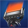 Close-up of a razor head with orange and blue visual effects. Produktbild-Vorschau