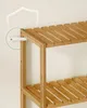 A close-up shot of a wooden shelf unit against a white wall. Produktbild-Vorschau