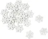 A collection of white glittery snowflake decorations scattered on a white background. Produktbild-Vorschau