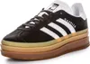 A studio shot of a black Adidas Gazelle Bold W sneaker with white stripes and a stacked gum sole. Produktbild-Vorschau