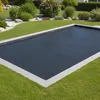 A rectangular pool cover is shown on a pool surrounded by a manicured lawn and garden. Produktbild-Vorschau