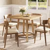 A dining set with a wooden table and four chairs in a room with a window overlooking a field. Podgląd zdjęcia produktu