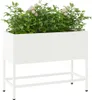 A white rectangular planter box filled with green plants and white flowers, elevated on a white metal stand. Produktbild-Vorschau