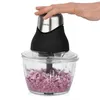 A hand pressing the button on a food chopper with chopped onions inside. Produktbild-Vorschau