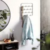 A hallway vignette featuring a key holder with a jacket and keys, a mirror, and a small console table. Produktbild-Vorschau