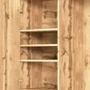 Close-up view of the interior of a wooden wardrobe with shelves. Voir les images du produit