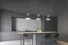 A modern kitchen with gray cabinets, a concrete tile backsplash, and a kitchen island with pendant lights. Produktbild-Vorschau