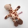 A plush toy giraffe lying on a white background. Produktbild-Vorschau