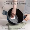 A person is cleaning the inside of a dark blue pot with a white cloth. Anteprima dell’immagine prodotto